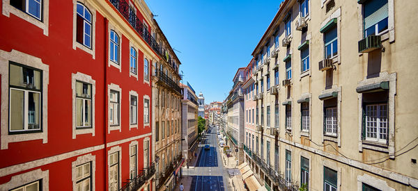 Road amidst buildings against sky