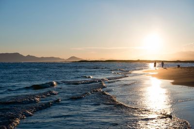 Scenic view of sea against clear sky during sunset