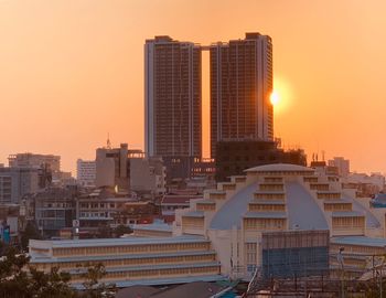 Modern buildings against sky during sunset