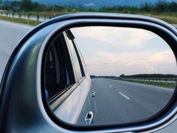 Close-up of side-view mirror of car