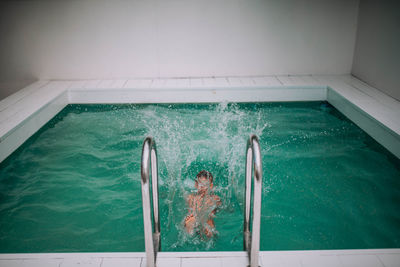 High angle view of woman swimming in pool