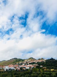 Buildings in town against sky