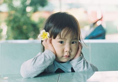 Portrait of cute girl at table