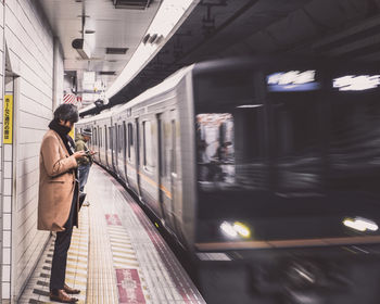 Man standing at railroad station