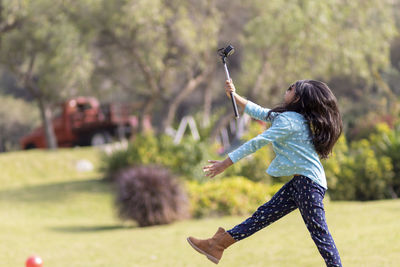 Girl taking selfie while standing on land