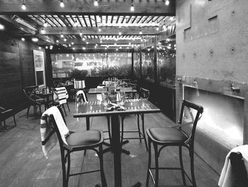 Empty chairs and tables in restaurant