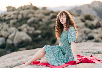 Young woman sitting on rock