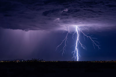 Lightning over landscape at night