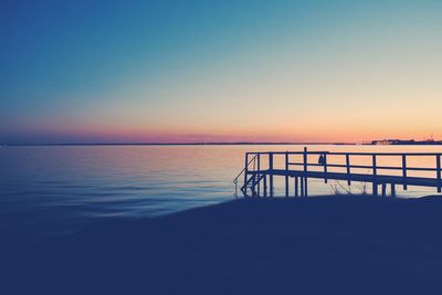 Scenic view of sea against clear sky during sunset