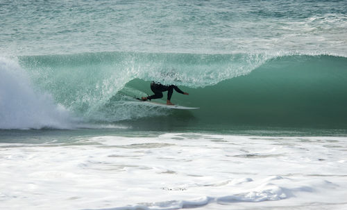 Person surfing in sea