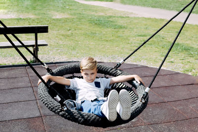 High angle view of boy sitting on floor