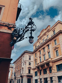 Low angle view of street light against cloudy sky