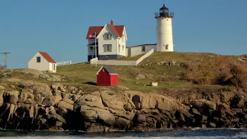 Lighthouse on shore against clear sky