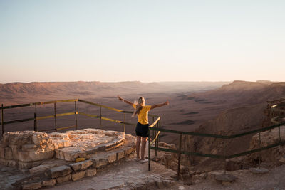 Full length of man standing on mountain against sky