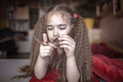 Portrait of young woman holding ice cream at home