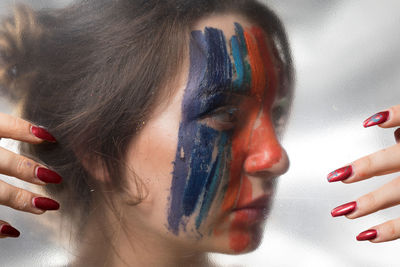 Close-up of woman seen through glass