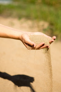 Close-up of hand holding sand