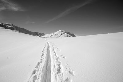 Scenic view of snow covered mountains against sky