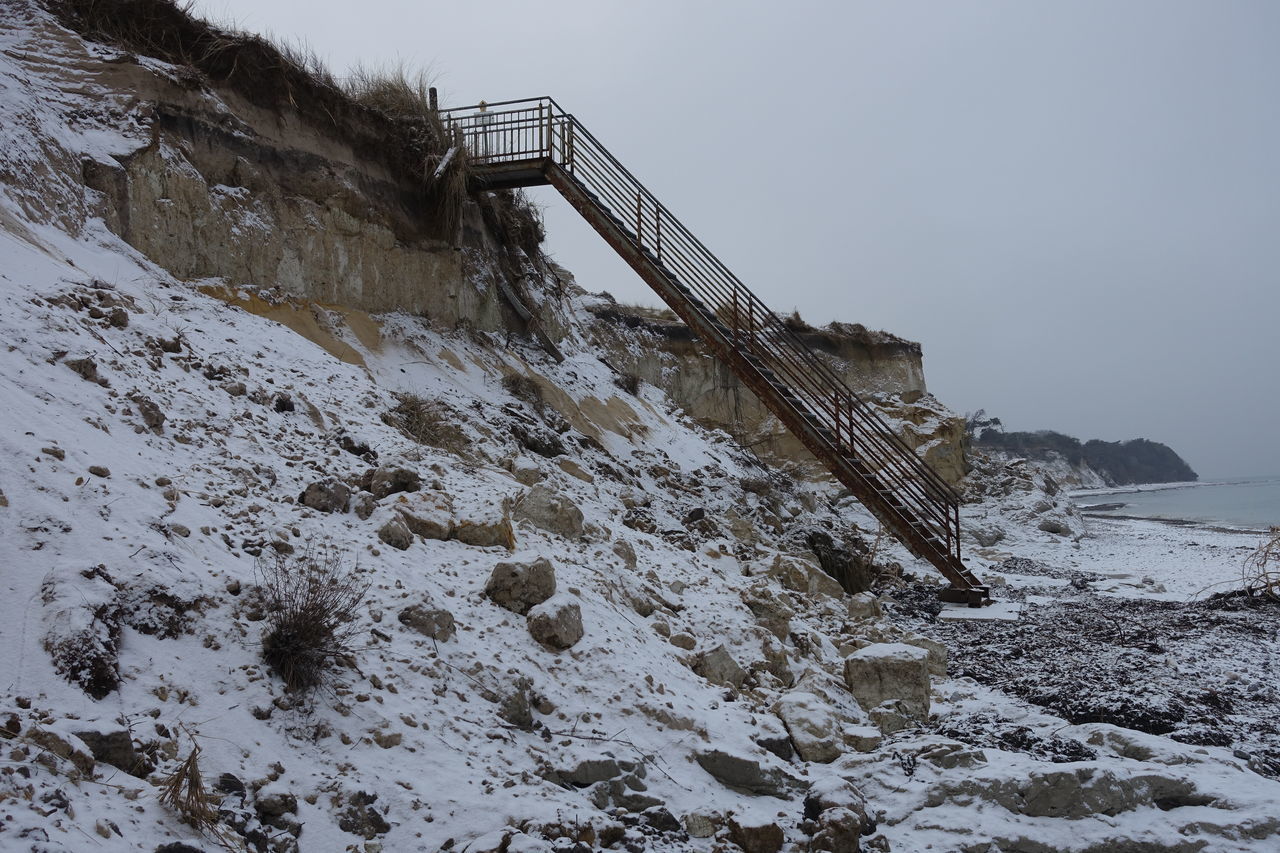 LOW ANGLE VIEW OF BRIDGE ON SHORE AGAINST SKY