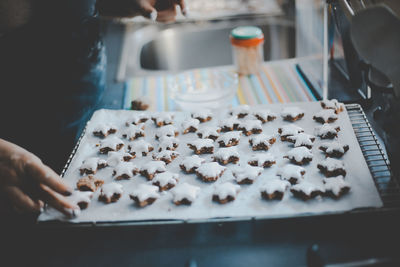 Cropped hand preparing food in kitchen