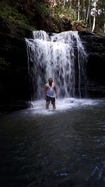 Water flowing amidst waterfall in forest