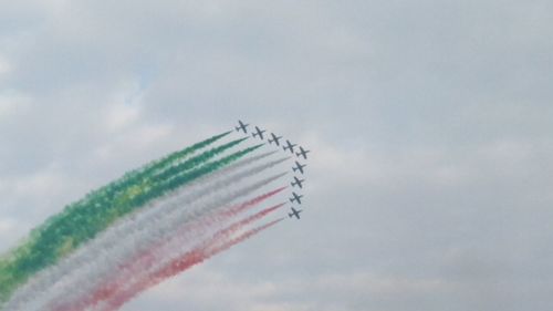 Low angle view of airshow against sky