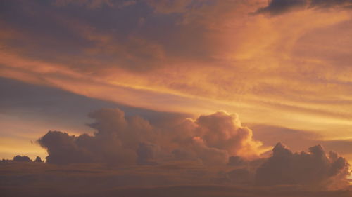 Low angle view of dramatic sky over sea during sunset