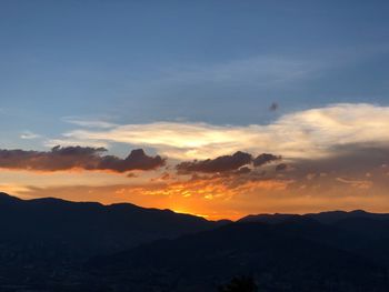 Scenic view of silhouette mountains against sky at sunset