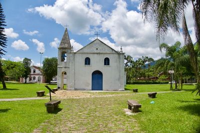 Church by building against sky