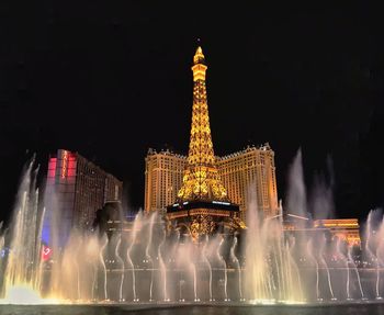 Illuminated buildings in city at night