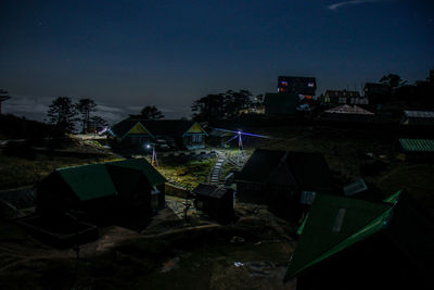 High angle view of buildings in city at night