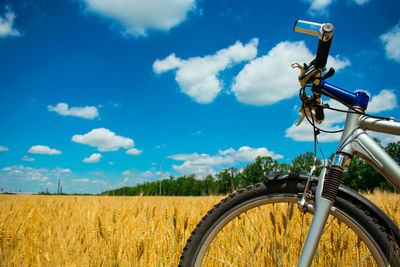 Bicycle on field against sky