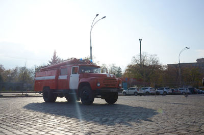 Vehicles on road in city against clear sky