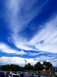 Cars on road against blue sky