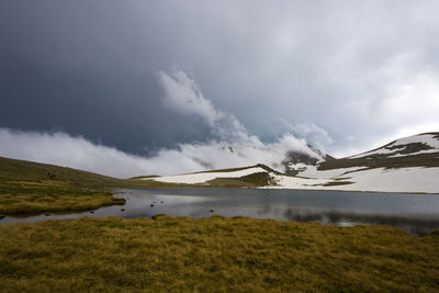 Alpine mountain lake landscape and view, snow and clouds in javakheti, georgia