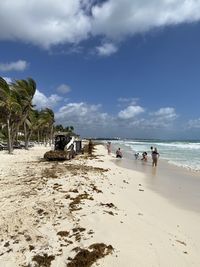 People on beach against sky