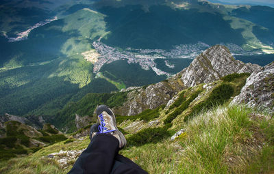 Low section of man sitting on mountain