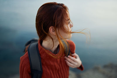 Midsection of woman standing against sea