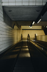 Rear view of woman on escalator