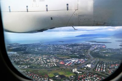 Aerial view of cityscape and sea against sky