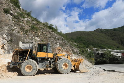 Construction site by road against sky