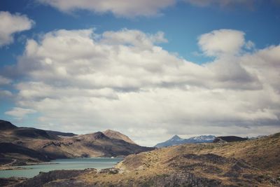 Scenic view of mountains against cloudy sky