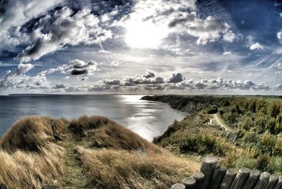 Scenic view of sea against cloudy sky