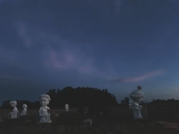 Statue against sky at night