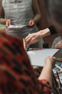 Midsection of women working on table