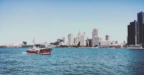 Scenic view of sea and buildings against clear sky detroit michigan boat ship 