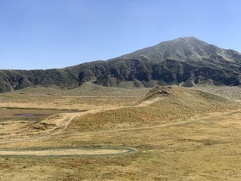 Scenic view of mountains against clear blue sky