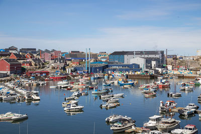 High angle view of boats moored at harbor in city