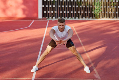 Full length of man stretching outdoors