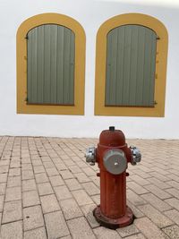 Fire hydrant on footpath by building